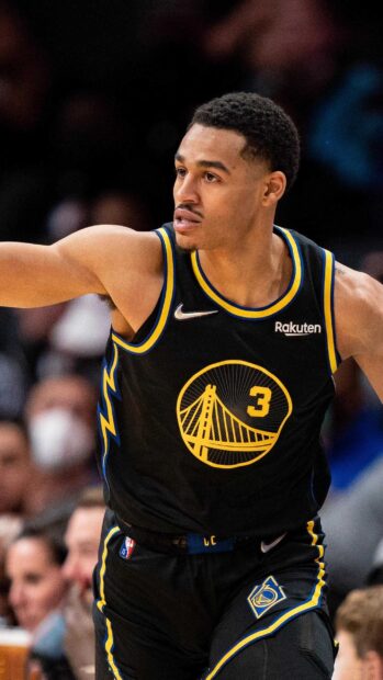Jordan Poole in Golden State Warriors uniform during a basketball game showing focus and determination
