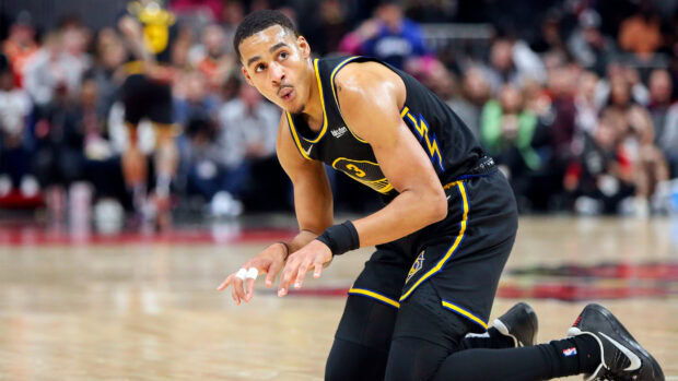 Jordan Poole preparing for a basketball play during an intense game