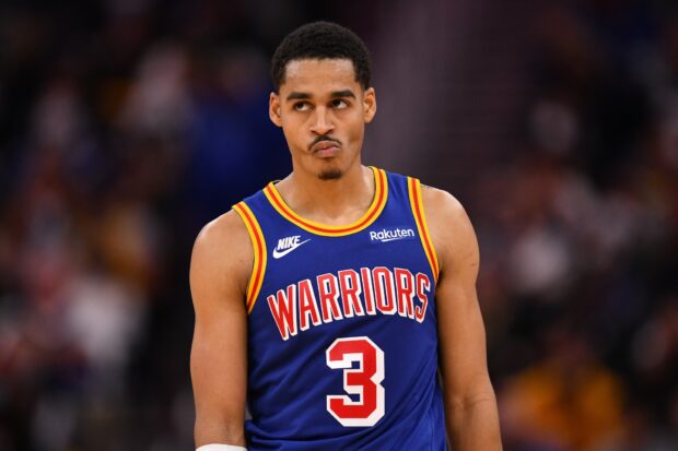 Jordan Poole wearing a Warriors jersey during a basketball game