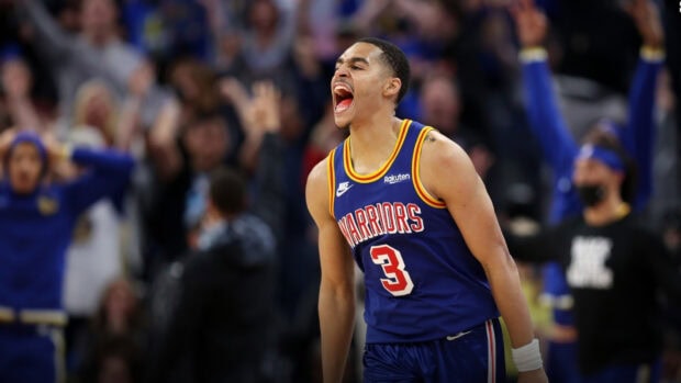Jordan Poole celebrating passionately during a basketball game in a Warriors jersey