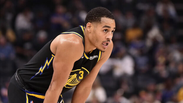 Jordan Poole focused during a basketball game in a Golden State Warriors jersey