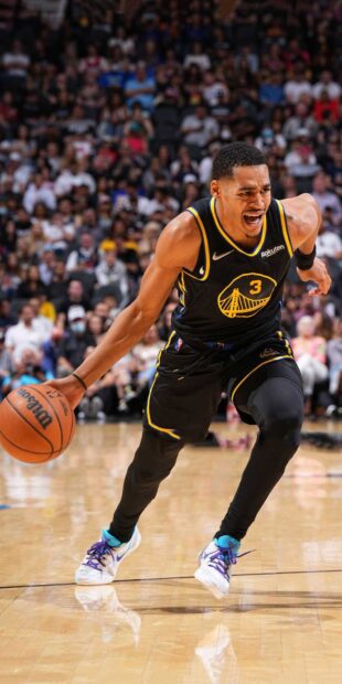 Jordan Poole in action during a basketball game showing intense focus on the court