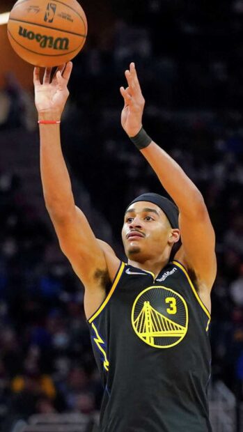 Jordan Poole shooting a basketball in a Warriors jersey during a game