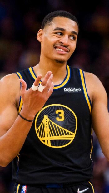 Jordan Poole celebrating during a basketball game in a Warriors jersey