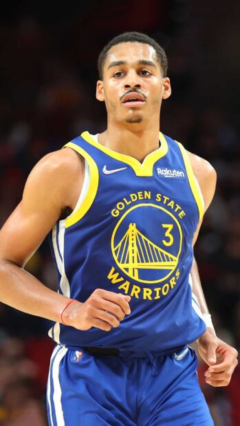 Jordan Poole wearing Golden State Warriors jersey during a basketball game on court