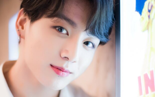 A close up portrait of Jungkook with soft lighting and a gentle expression