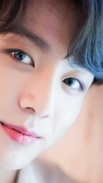 Close up of Jungkook showing his clear skin and bright eyes