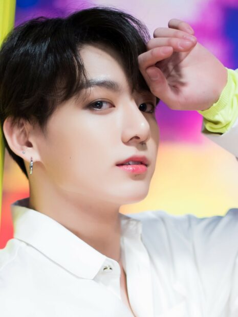 Jungkook close up portrait with a colorful background and a bright expression