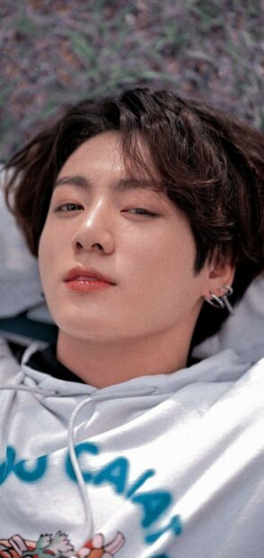Close up portrait of Jungkook lying down with casual hairstyle