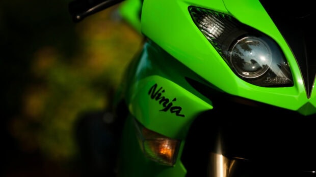 Close up of Kawasaki Ninja motorcycle headlight and fairing in bright green color