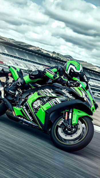 Kawasaki motorcycle rider racing on a track with Kawasaki branding and green racing suit