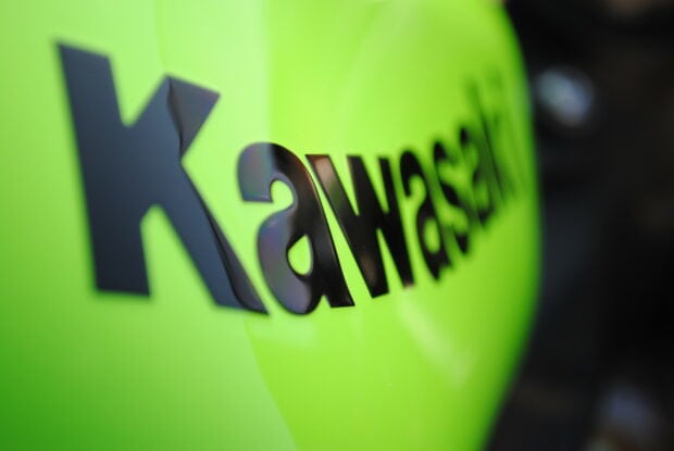 Close up of Kawasaki logo on a bright green surface in high definition