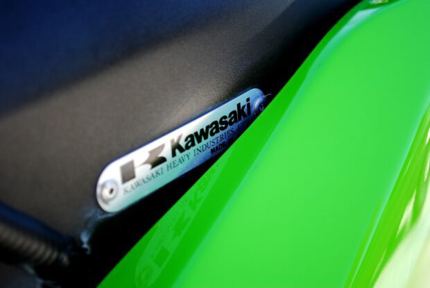 Close up of Kawasaki logo on green motorcycle seat
