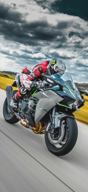 Professional rider on Kawasaki motorcycle racing on highway