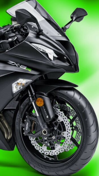 Close up of Kawasaki ZX6R front wheel and headlight on green background