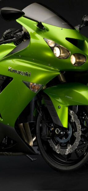 Green Kawasaki motorcycle front view with detailed brake system and headlights
