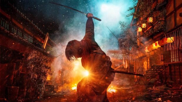 Kenshin warrior raising sword amidst fiery battle in a traditional Japanese village