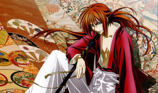 Kenshin sitting on a colorful patterned floor with his sword resting on his shoulder