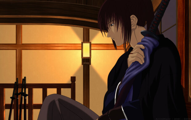 Kenshin is sitting quietly indoors holding a sword in a traditional room with warm lighting
