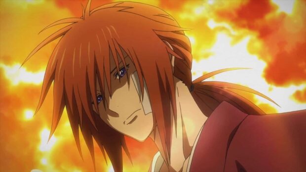 Kenshin with red hair and a bandage on his face in a fiery background