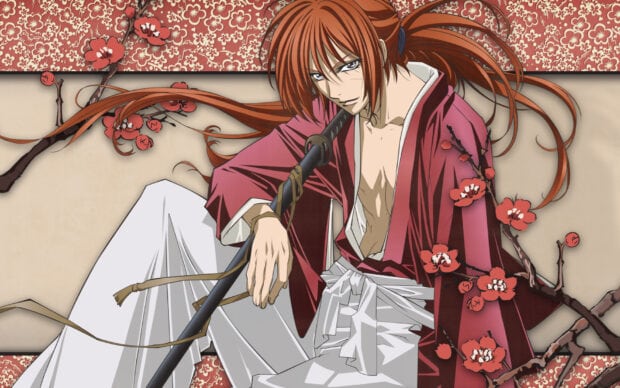Kenshin sitting with a sword in traditional Japanese clothing surrounded by cherry blossoms