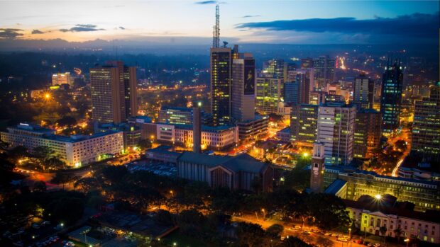 Nighttime cityscape of Kenya showcasing illuminated buildings and urban lights in the evening
