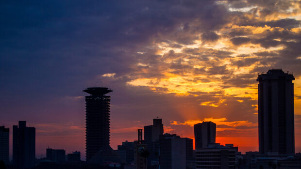 Nairobi city skyline at sunset with Kenya landmarks and colorful clouds