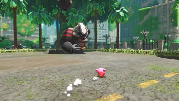 A large badger like enemy chasing Kirby in a lush urban environment