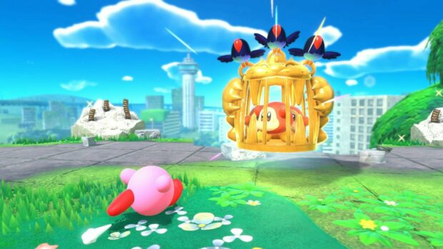 Kirby captures a red enemy trapped in a golden cage in a colorful landscape