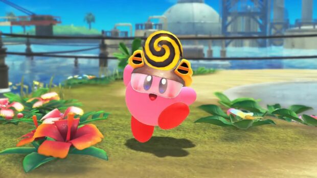 Kirby wearing a helmet and glasses in a colorful outdoor scene from Kirby And The Forgotten Land