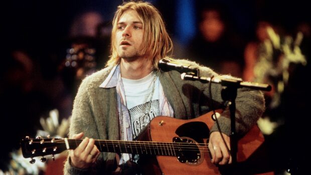 Kurt Cobain playing guitar during an intimate live performance with acoustic guitar