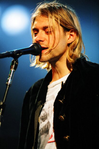 Kurt Cobain performing on stage with microphone in front of him