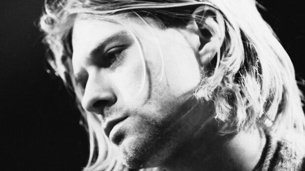Close up of Kurt Cobain with long hair and a thoughtful expression