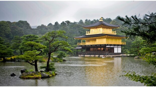 Golden Pavilion surrounded by serene lake and lush greenery in Kyoto