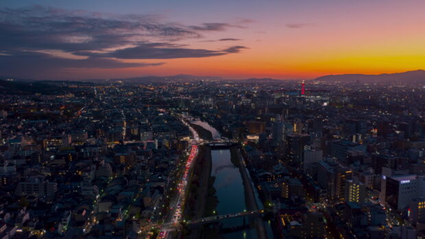 Night view of Kyoto city skyline with river and sunset sky in Kyoto