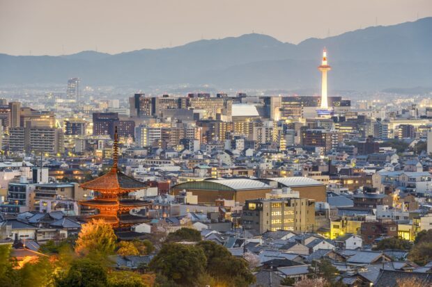 Traditional Kyoto architecture blends with modern cityscape during sunset in Kyoto