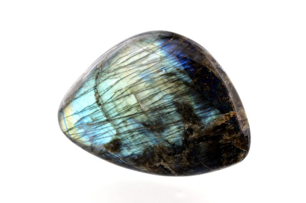 Polished labradorite stone with blue and green iridescence on a white background