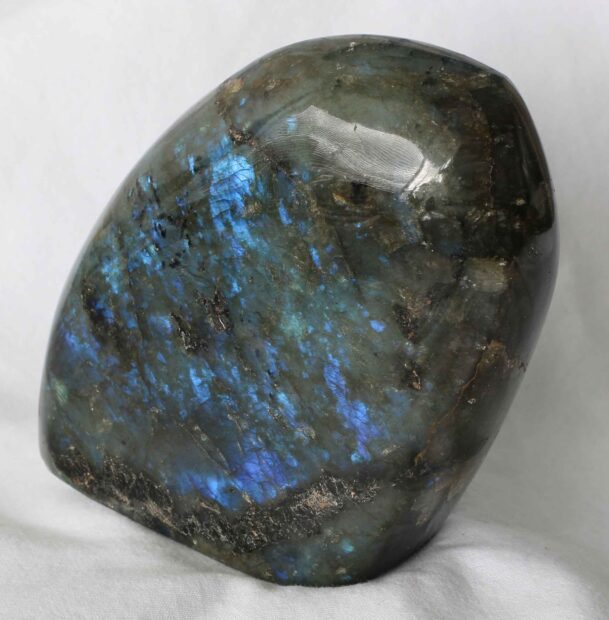 Polished labradorite stone showing natural blue flashes and unique mineral patterns