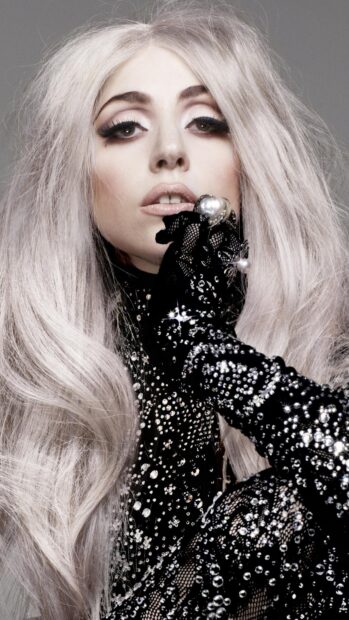 Lady Gaga wearing a sparkling black outfit with long platinum blonde hair and dramatic makeup