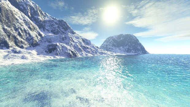 Clear lagoon surrounded by snowy mountains under bright sunlight