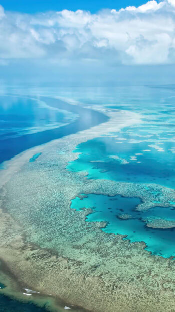 Aerial view of a vibrant lagoon with turquoise waters and coral reefs in clear calm weather