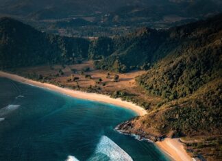 Aerial View Of Lagoon Surrounded By Hills And Sandy Shoreline