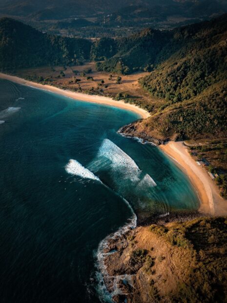 Aerial View Of Lagoon Surrounded By Hills And Sandy Shoreline