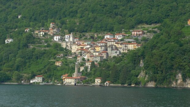 A scenic view of Lake Como village nestled among lush green mountains