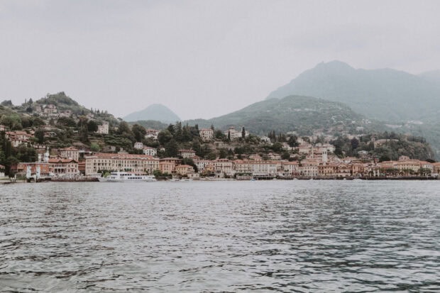 A peaceful town near Lake Como surrounded by mountains and calm water