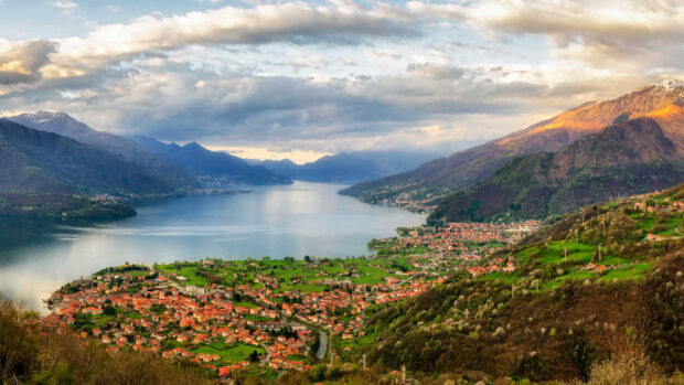 A scenic view of Lake Como with surrounding mountains and vibrant green villages