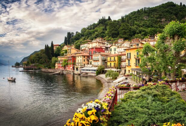 Colorful houses and lush greenery along Lake Como shore in a scenic village