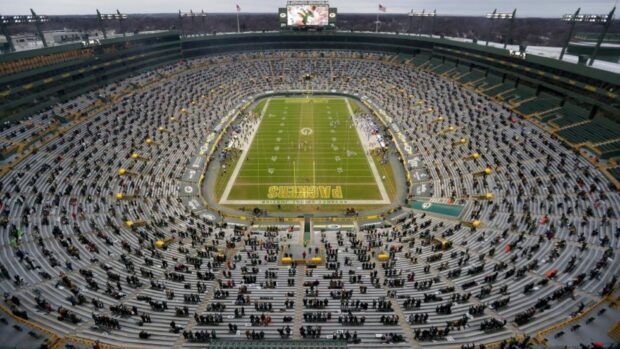A wide view of Lambeau Field showing the Green Bay Packers football stadium and seats filled with fans