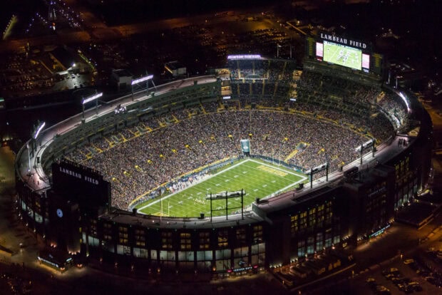 Aerial view of Lambeau Field filled with fans during a night game in high definition quality