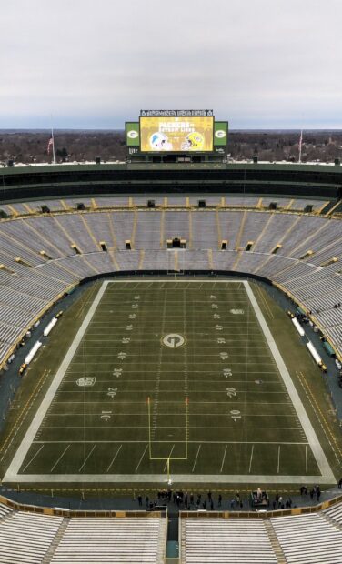 Aerial view of Lambeau Field football stadium with empty stands and field markings
